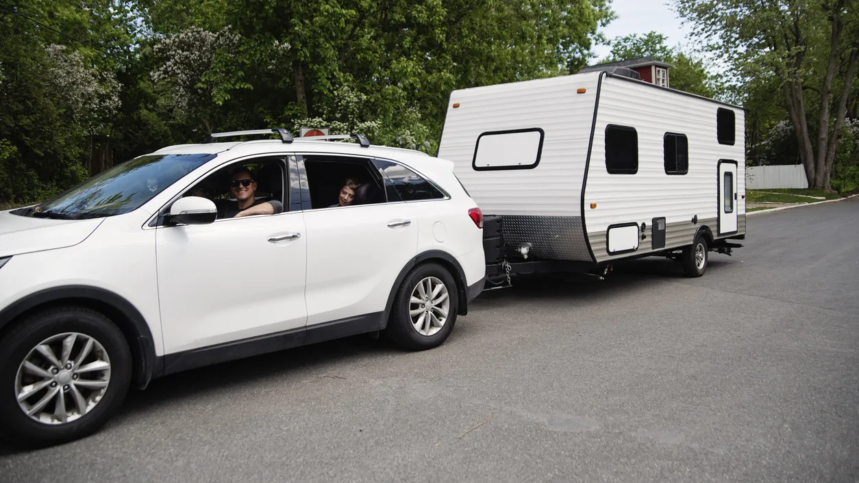 Family with midsize travel trailer.