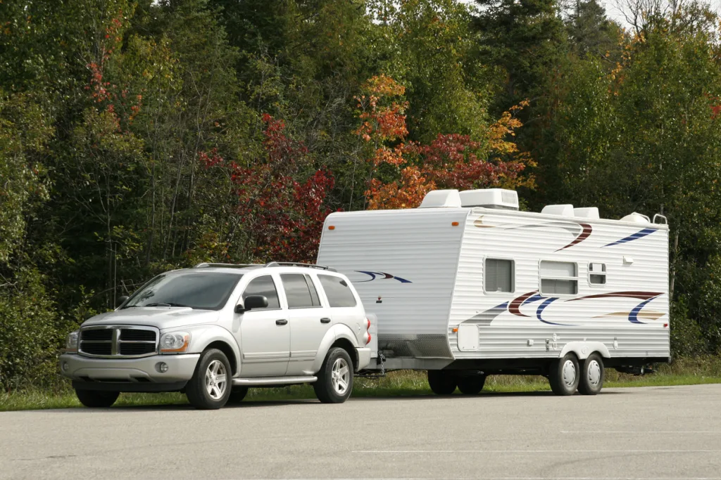 Full size SUV with travel trailer.